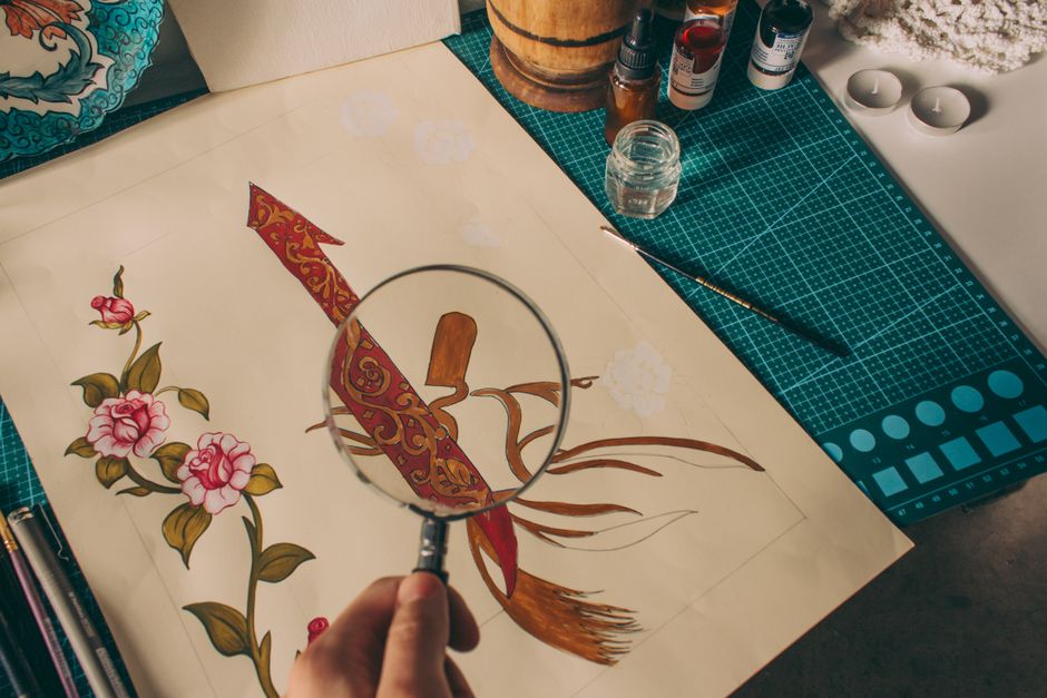 Detailed illustration of flowers and sword examined with a magnifying glass.